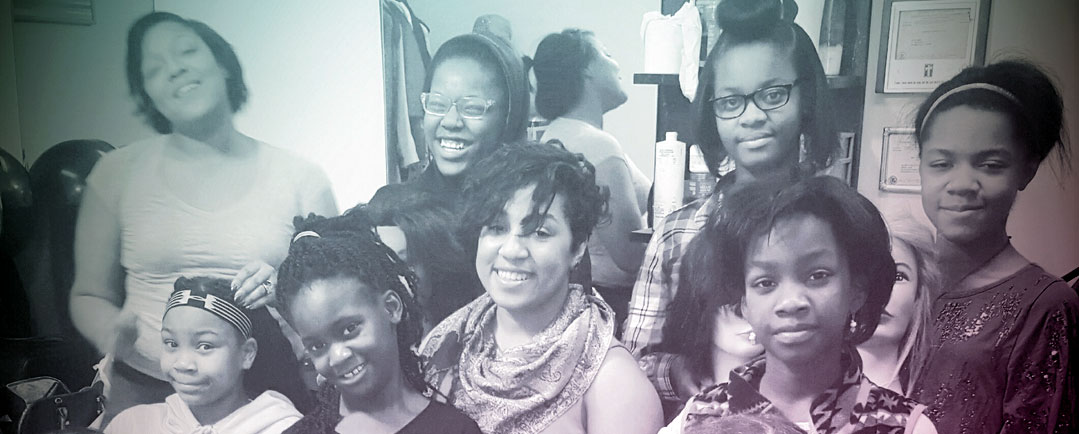 Black and white group photo of women and girls looking at the camera.